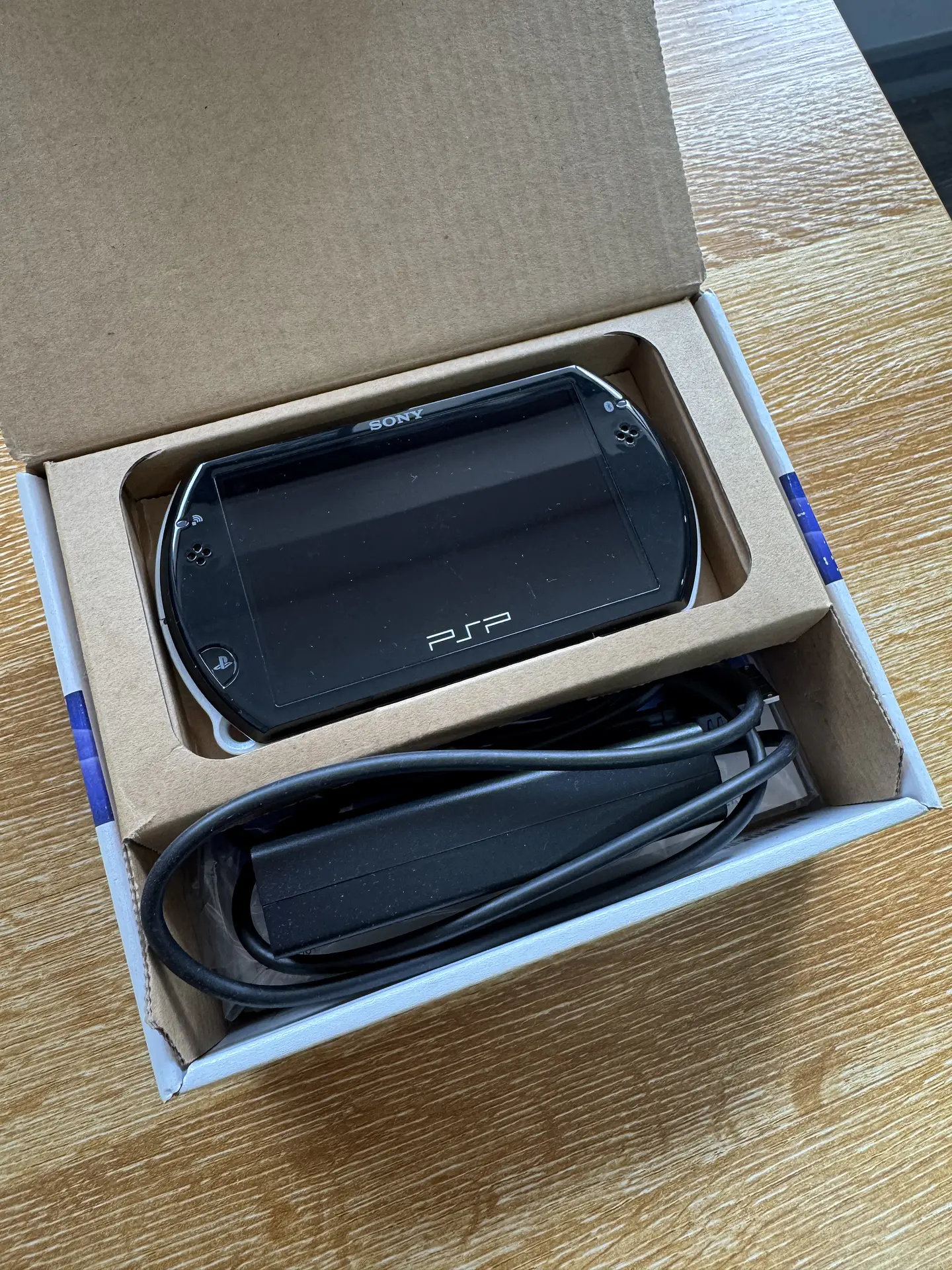 Sony PlayStation Portable Go 16 GB black box and charger 3