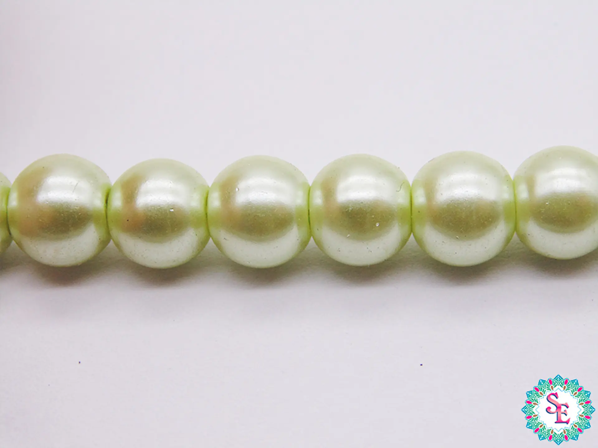 PERLA DE VIDRIO REDONDA # 8M VERDE PASTEL X 115 UND APROX  1