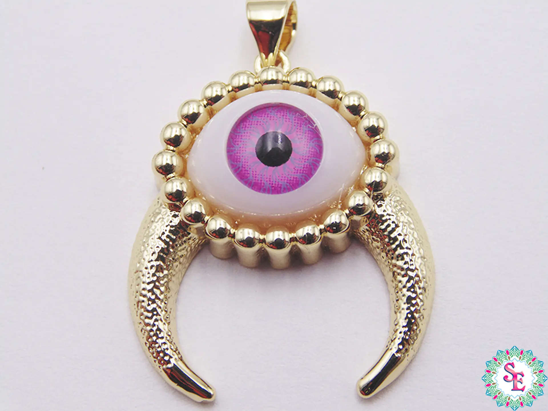 RODIO DORADO DIJE OJO FUCSIA CACHOS 26MM  1