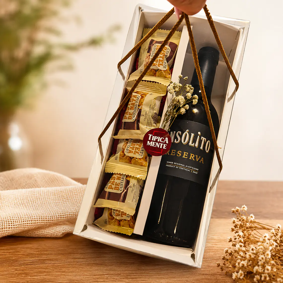 Gourmet box with handles containing a drink and chocolate. 1