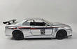 NISSAN SKYLINE GT R 34 PLATEADO , ESCALA 1/32, MARCA JADA