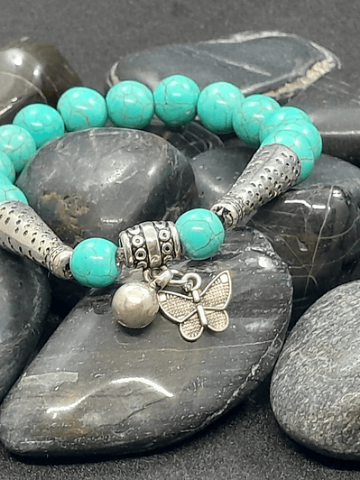 Pulsera piedras turquesa dije Mariposa.