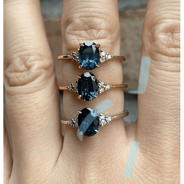 Anillo tradicional con topacio london blue y con 3 moissanitas de casa lado, en Plata Ley 925 en baño de oro. Talla 7.5 