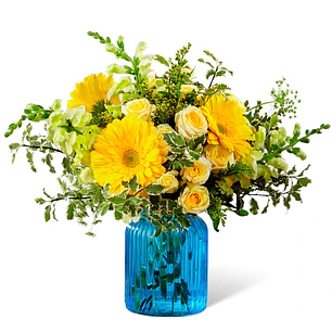 Florero azul mixto de flores amarillas