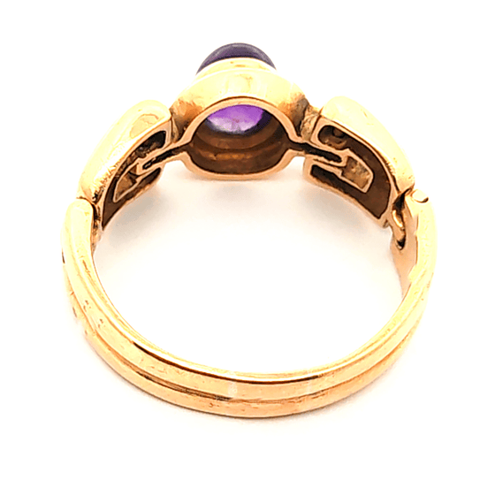 Anillo de oro 18k con piedra ovalada central de color morado, peso 9,05 grs, talla 22 3